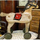 Antique painted pine child's toy horse on wheels with galloping movement