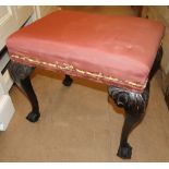 A mahogany dressing stool with acanthus leaf carved cabriole legs.