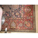 Large red ground Persian design rug,