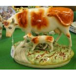 A Staffordshire pottery cow and calf.