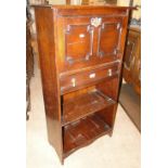 An oak student's bureau with panelled fall front and drawers and shelves under.