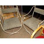 Pair of wrought iron X framed chairs with upholstered seats