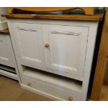 A painted pine cabinet with drawers and cupboards.