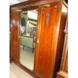 Victorian mahogany 3 door compactum wardrobe with applied carved decoration on bun feet