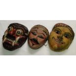 Three painted wooden masks.