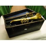 A cased Boosey & Co., cornet with mouthpiece, and music clip.