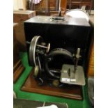 An early Willcox & Gibbs sewing machine in original painted case.