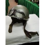 A 1953 TT Motor cycle helmet, and Mark 8 chromed goggles.