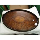 An Edwardian inlaid oval tea tray with brass handles.