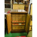 A table top coin collector's chest with brass carrying handles.