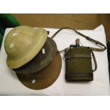 3 Army helmets and a flask.