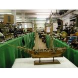 A wooden American War of Independence model of a 2 masted sailing ship with rigging.