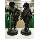 A pair of patinated spelter Musketeers on circular plinths