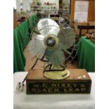 A Limit electric fan for ornamental use and a Nixey's black lead box.