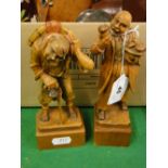 A pair of continental carved wood figures on plinths, height 6.75".