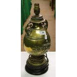 A Victorian embossed brass table lamp with wheatear decoration.