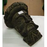 A carved wood head of a man.
