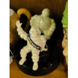 Vintage ceramic Michelin Man ashtray and a dashboard figure.