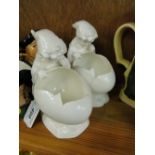 Pair of continental porcelain bowls modelled as broken egg shells with figures of children,
