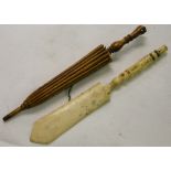 A letter opener with stanhope and a carved parasol with stanhope.
