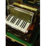 An Estrella piano accordion with case.