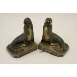 Pair of 1930s silvered metal bookends formed as sea lions, by George H Laurent, signed,