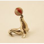 Modern silver and enamelled sea lion, worked balancing a ball on its nose,