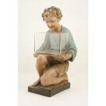 Edwardian painted plaster figure of a boy, kneeling and holding a fish tank,