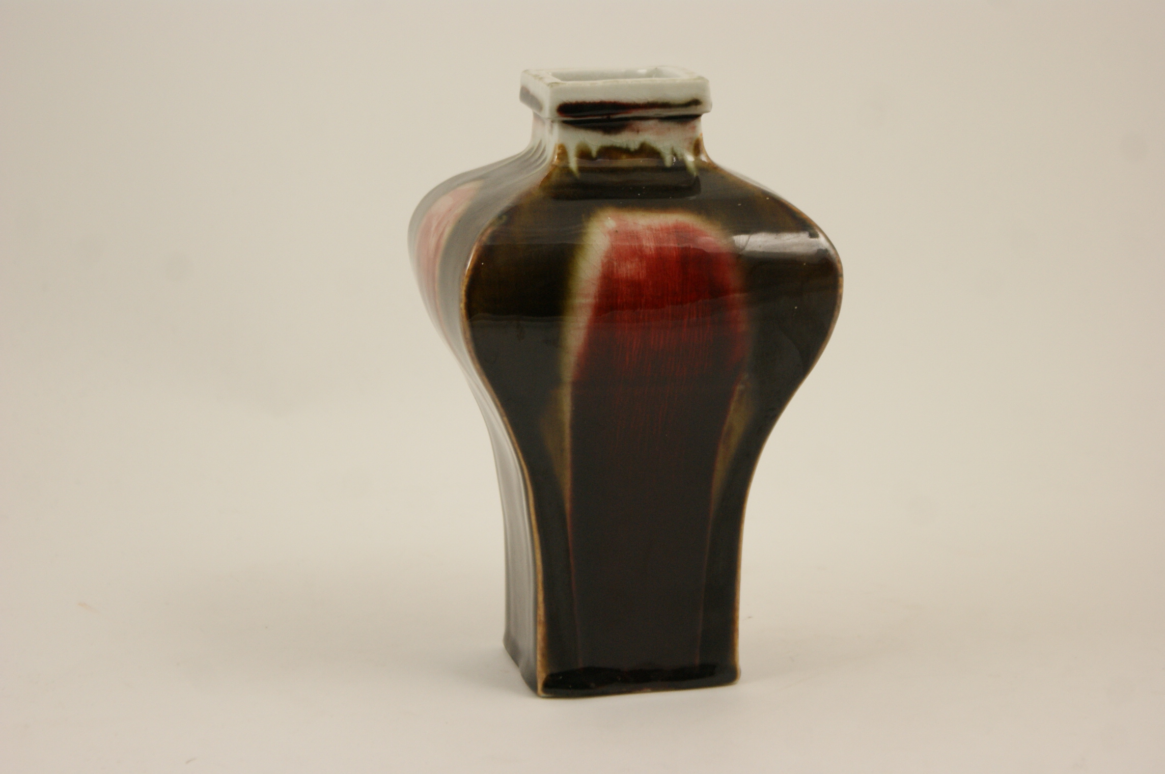 Chinese flambe inverted baluster vase, square section decorated with streaked red,