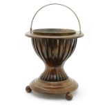 Late Victorian mahogany wine cooler, circular form with copper liner and swing handle,