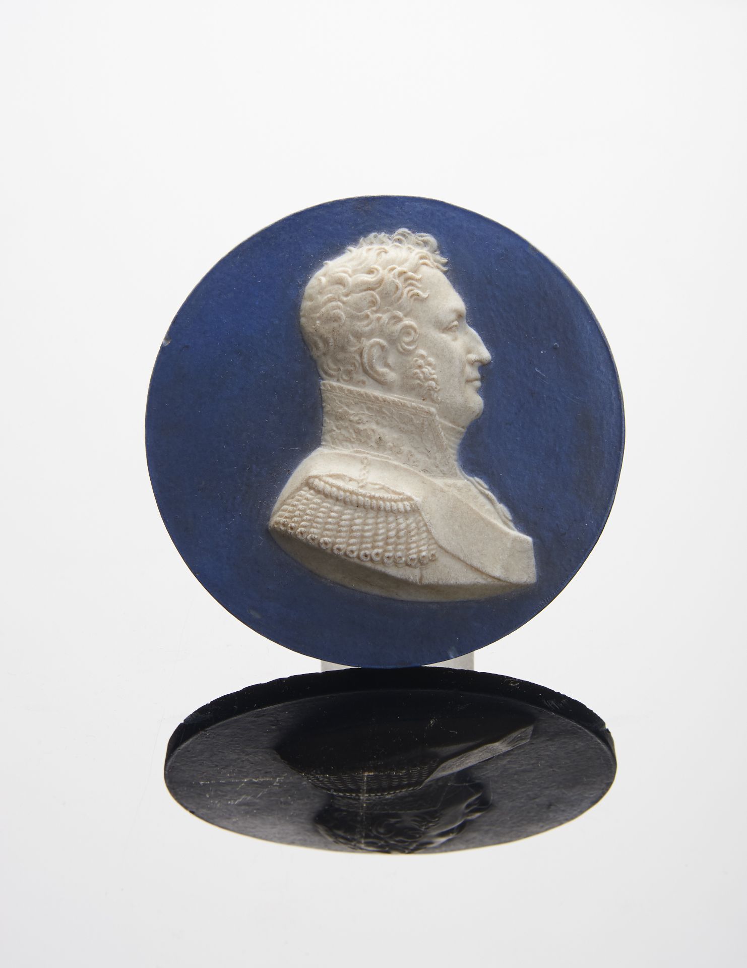An Effigy of a Military, blue and white biscuit medallion en relief, European, 19th C. (1st