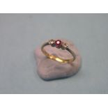 An 18ct. gold half-hoop ring, ruby and two diamonds in platinum claw setting, size M/N