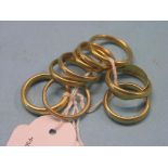 Ten 22ct. gold band wedding rings, 44.8 grams total