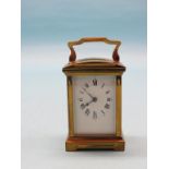 An early 20th century French carriage clock, with enamelled dial and oval chapter ring, timepiece