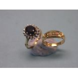 An 18ct. gold and diamond-chip cluster ring, claw-set large central red stone, together with an