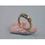 An 18ct. gold and diamond half-hoop ring, five graduated diamonds, size S