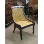 A pair of early 19th century rosewood bergere single chairs, curved backs with scroll terminals,