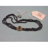 A Victorian/Edwardian garnet three-row necklace, with yellow metal clasp, and pair of matching ear-