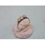 An 18ct. gold half-hoop ring, three diamonds in platinum claw setting, size N, principal stone