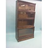 A dark oak Globe Wernicke bookcase, four glazed sections with base drawer, 2ft. 10in.