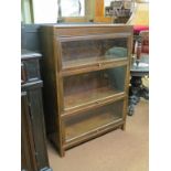 An early 20th century Angus sectional bookcase, three walnut glazed sections, 2ft. 10in.