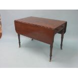 An early 19th century mahogany Pembroke table, frieze with two drawers, turned wood knob handles, on