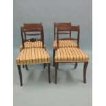 A set of three Regency-period mahogany dining chairs, horizontal, reeded bar-backs, on moulded front