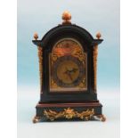 A late 19th century ebonised bracket clock in Georgian style, arched brass dial with silvered