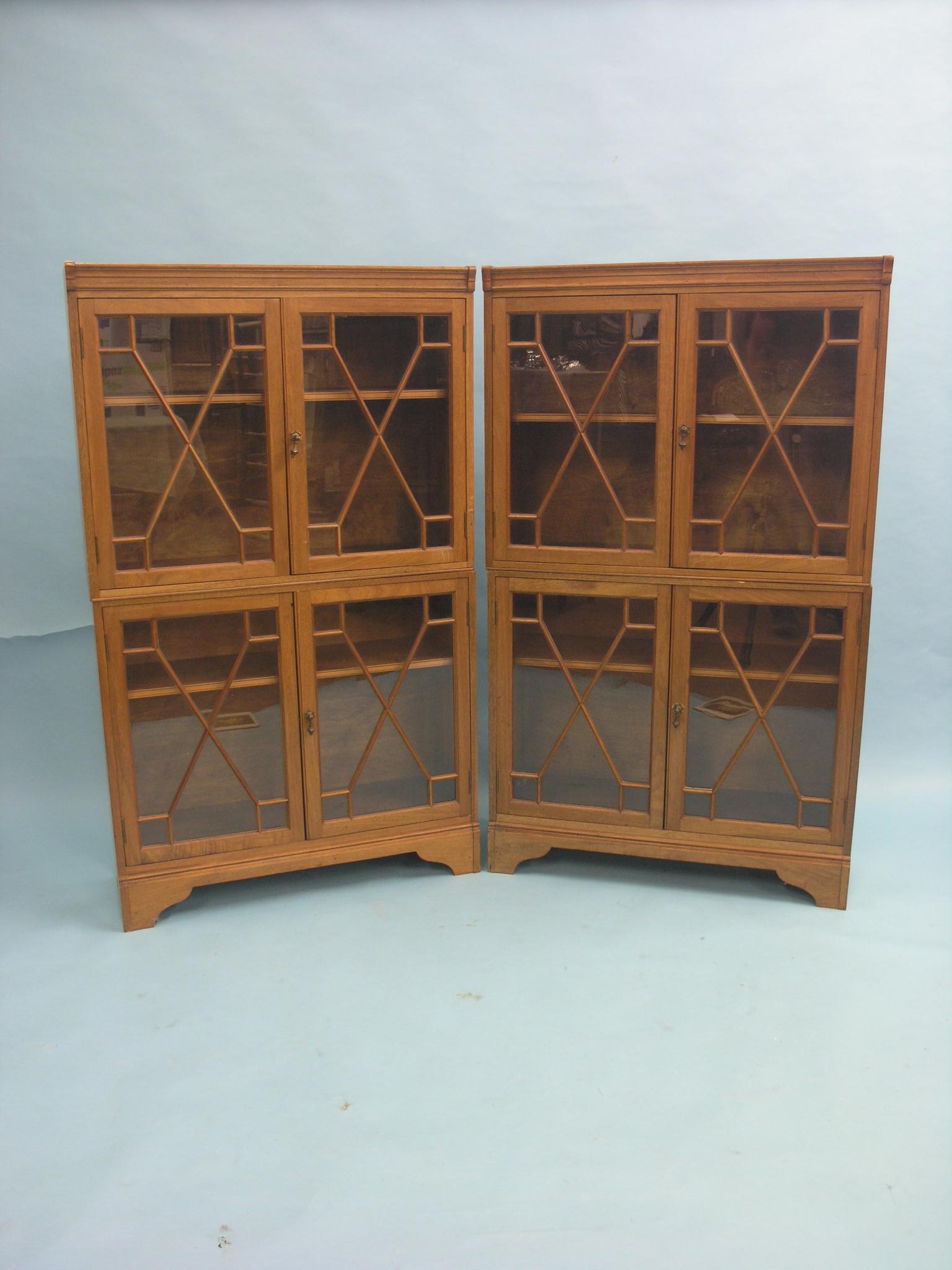 A pair of solid walnut bookcases, Morris & Co. Art-Workers Ltd., each in two sections, enclosed by