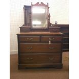 A late Victorian mahogany dressing chest, adjustable mirror above two trinket drawers, two short and