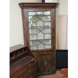 A Georgian stained pine standing corner cabinet, astragal-glazed single door enclosing shaped,