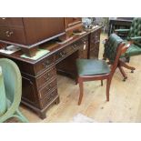 A reproduction mahogany desk, inset gilt-tooled leather top above three frieze drawers, further