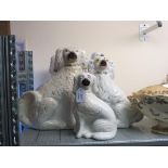 A pair of Victorian Staffordshire comforter spaniels, 12.5in., and three other similar spaniels