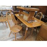 An Ercol golden elm dining suite, six-seater table, set of four stick-back chairs, similar child's